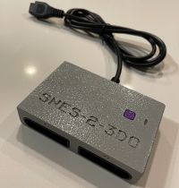 Controller Adapter SNES-2-3DO (Gray/Purple) Box Art